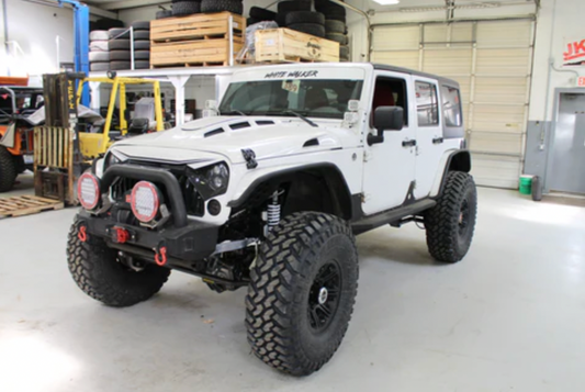 White 2013 Jeep Wrangler Unlimited called White Walker in a shop garage